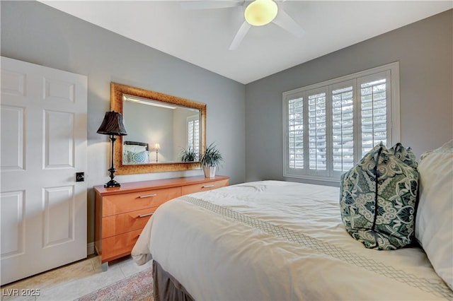 tiled bedroom featuring ceiling fan