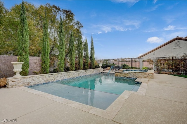 view of swimming pool featuring an in ground hot tub and a patio area