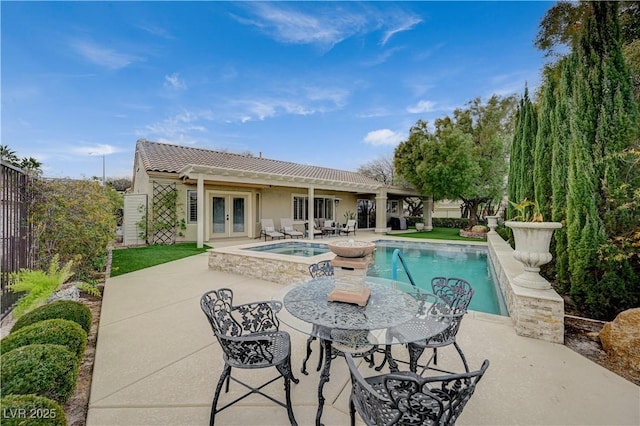 view of pool with an in ground hot tub, a patio area, and french doors