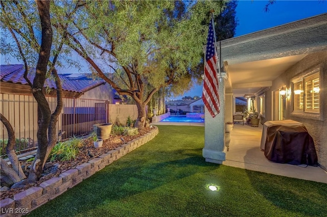 view of yard with a fenced in pool and a patio area