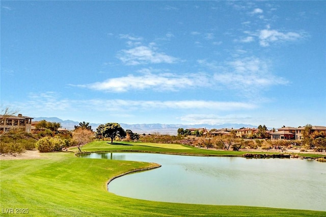 surrounding community with a water and mountain view and a lawn