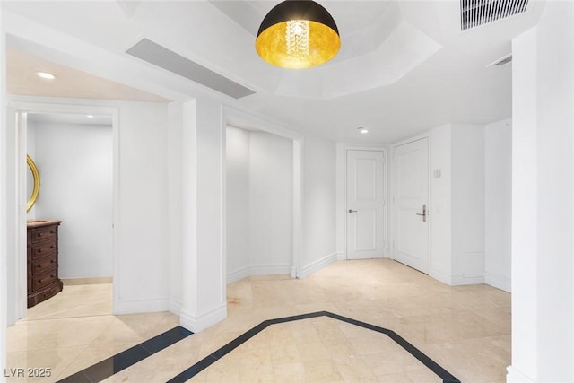 unfurnished room featuring visible vents, baseboards, a raised ceiling, and recessed lighting