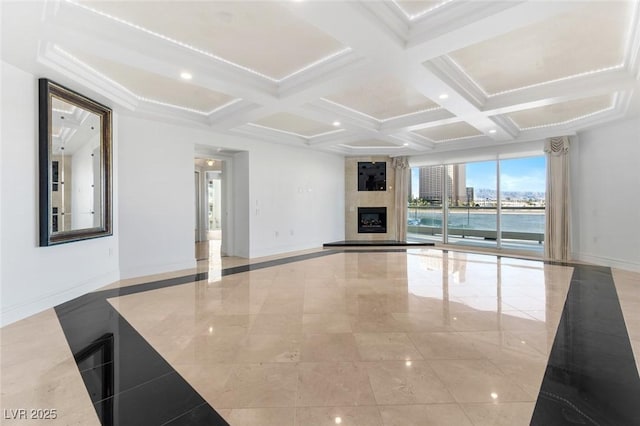 unfurnished living room featuring a water view, beam ceiling, a fireplace, and coffered ceiling