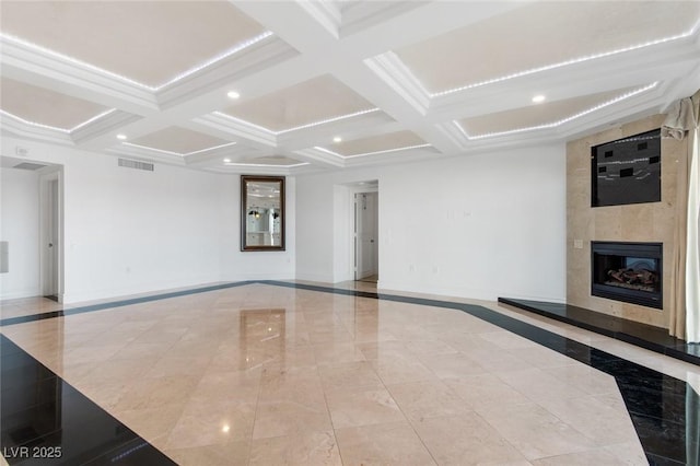 unfurnished living room with a large fireplace, coffered ceiling, visible vents, and baseboards