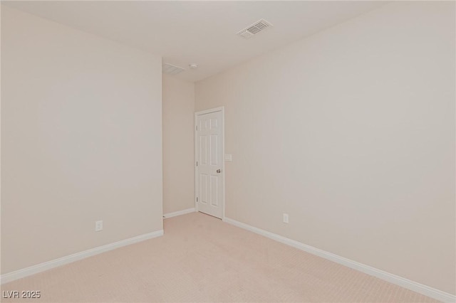 unfurnished room featuring light colored carpet