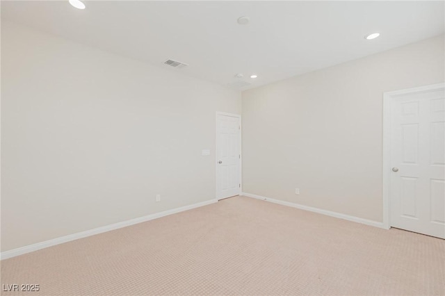 unfurnished room featuring light carpet