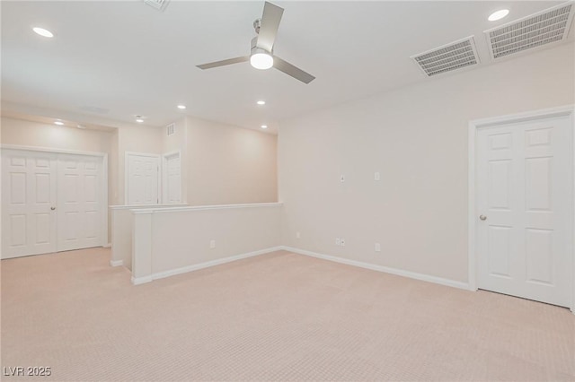 carpeted spare room with ceiling fan