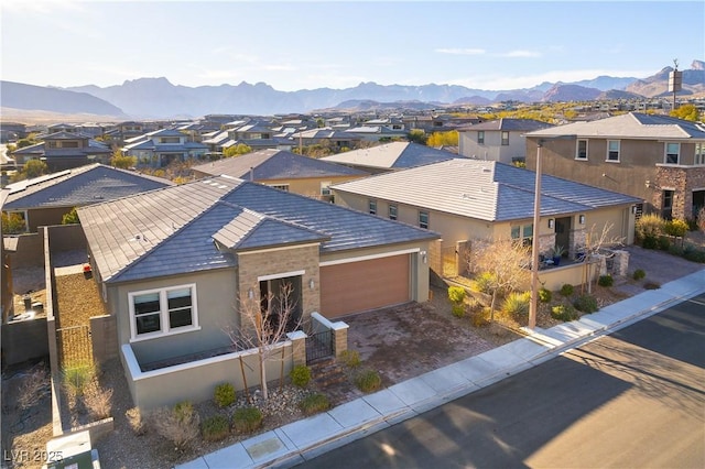 view of front facade featuring a mountain view and a garage