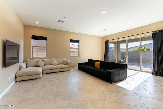 living room with light tile patterned floors and a healthy amount of sunlight