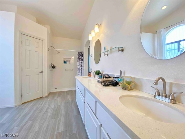 bathroom featuring walk in shower, vanity, and hardwood / wood-style floors