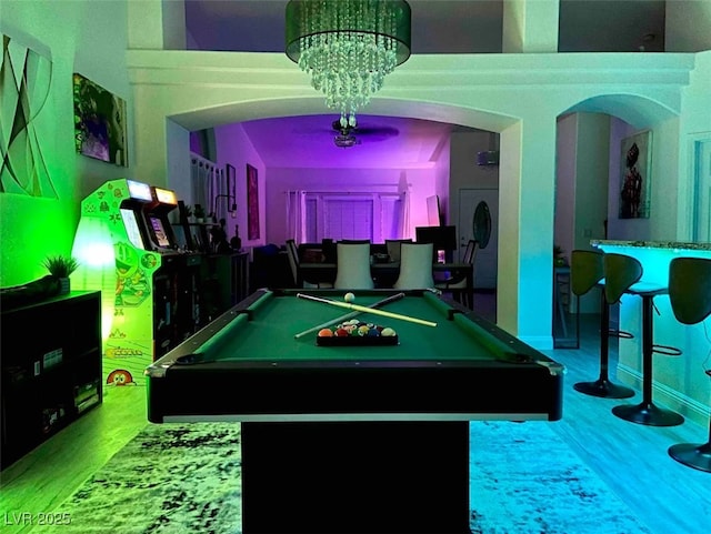 game room featuring pool table and a chandelier