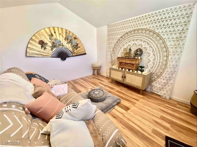 sitting room with lofted ceiling and hardwood / wood-style floors