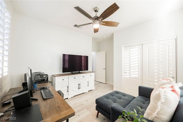 office area with ceiling fan and light hardwood / wood-style flooring