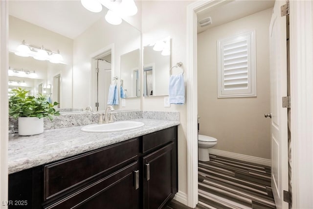 bathroom featuring vanity and toilet