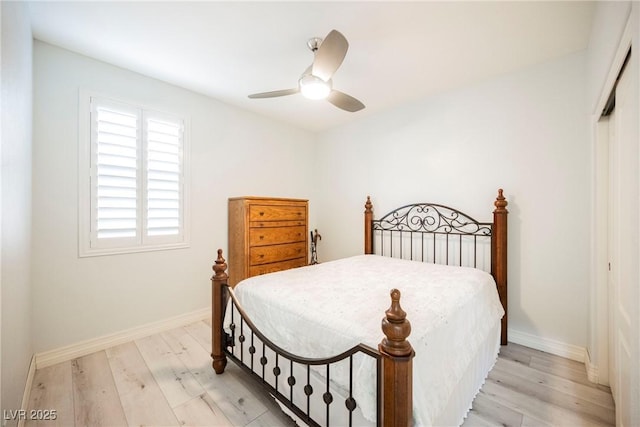 bedroom featuring light hardwood / wood-style floors, a closet, and ceiling fan