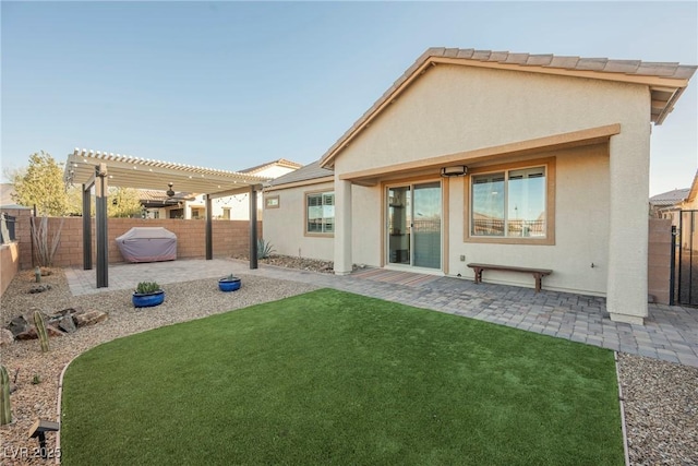 back of property featuring a patio, a yard, and a pergola