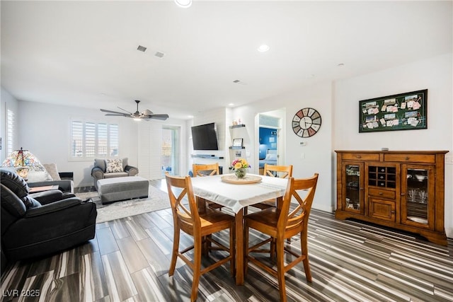 dining room with wood-type flooring and ceiling fan