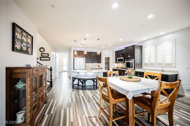 dining space with hardwood / wood-style floors