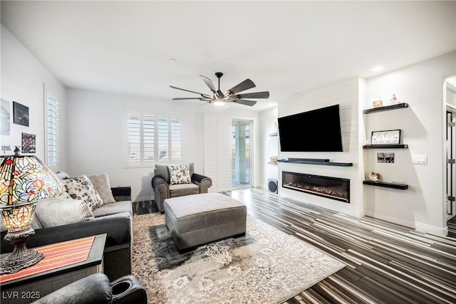 living room with hardwood / wood-style floors and ceiling fan