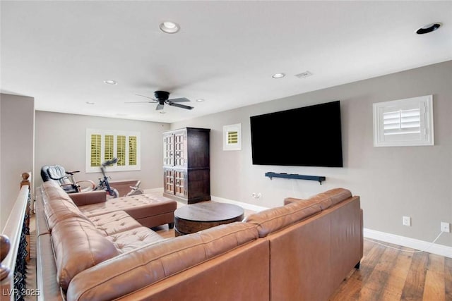 living room featuring ceiling fan and light hardwood / wood-style flooring