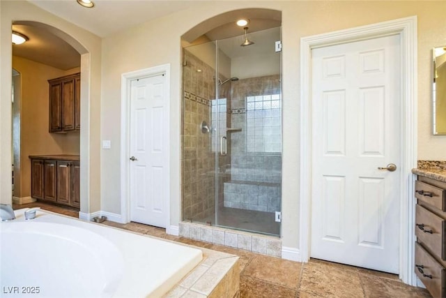 bathroom with vanity and plus walk in shower