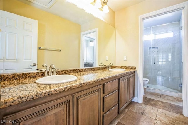 bathroom with toilet, a shower with shower door, and vanity