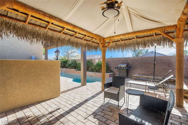 view of patio featuring a gazebo and a grill