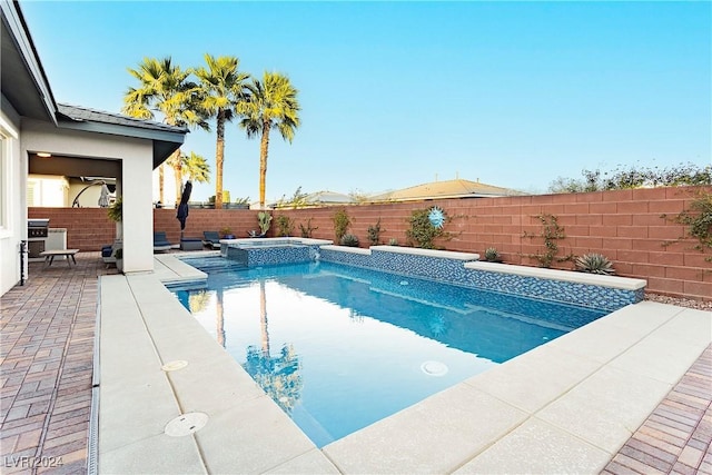 view of swimming pool featuring an in ground hot tub and a patio