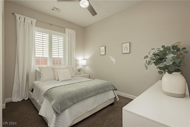 bedroom featuring ceiling fan and dark carpet