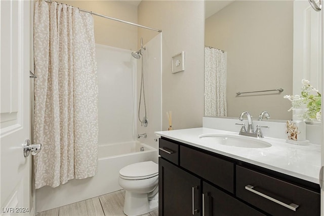 full bathroom featuring toilet, shower / bathtub combination with curtain, and vanity