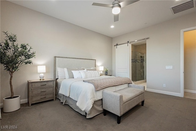 carpeted bedroom featuring ceiling fan, connected bathroom, and a barn door