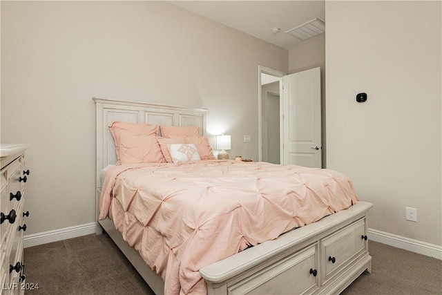 bedroom with dark colored carpet