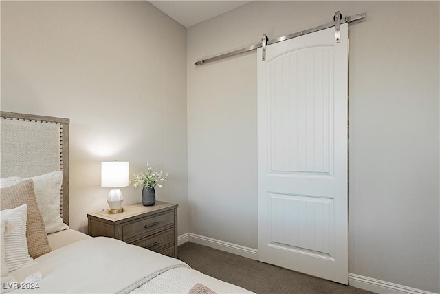 carpeted bedroom featuring a barn door