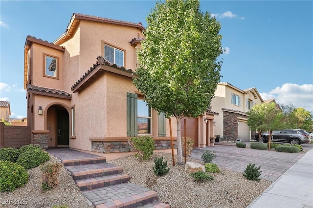 mediterranean / spanish home with a garage