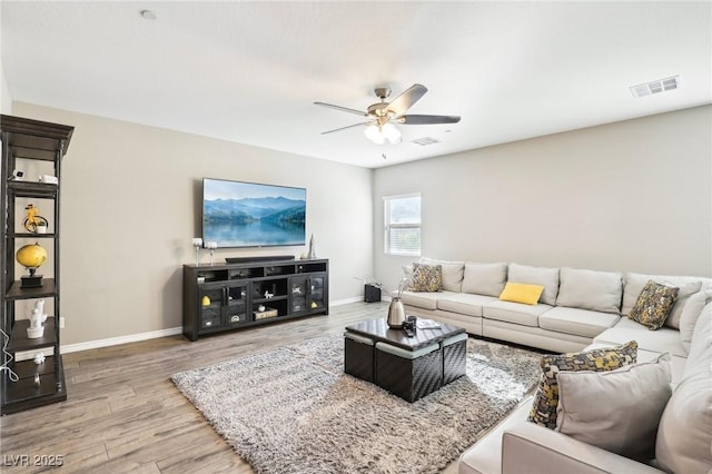 living room with ceiling fan and hardwood / wood-style flooring