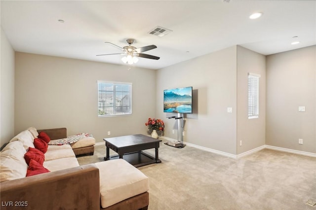 carpeted living room featuring ceiling fan