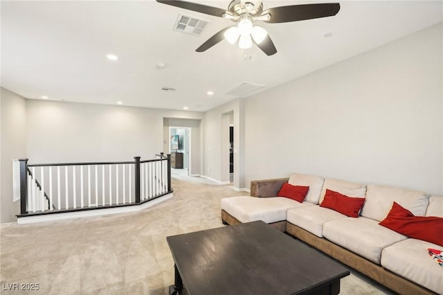 living room with ceiling fan and light colored carpet