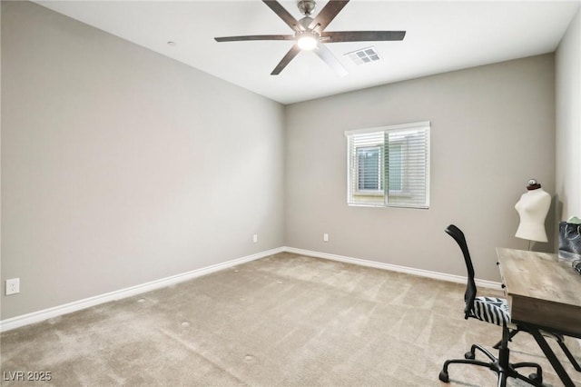 unfurnished office with ceiling fan and light colored carpet