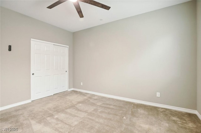 unfurnished bedroom featuring ceiling fan, a closet, and light carpet