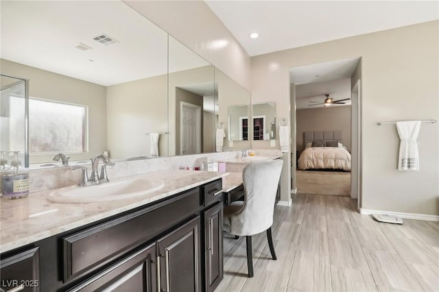 bathroom featuring ceiling fan and vanity