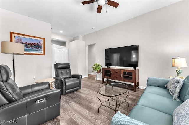 living room with wood-type flooring and ceiling fan