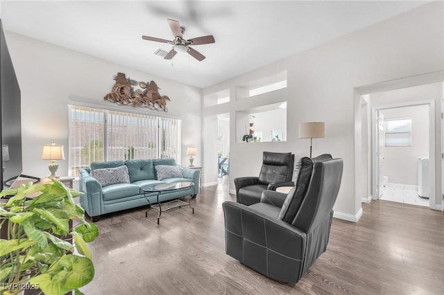 living room with hardwood / wood-style floors and ceiling fan