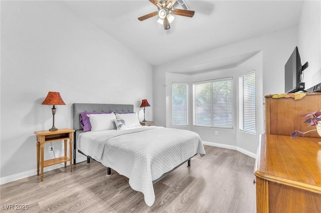 bedroom with lofted ceiling, hardwood / wood-style flooring, and ceiling fan