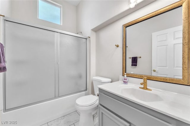 full bathroom featuring enclosed tub / shower combo, vanity, and toilet