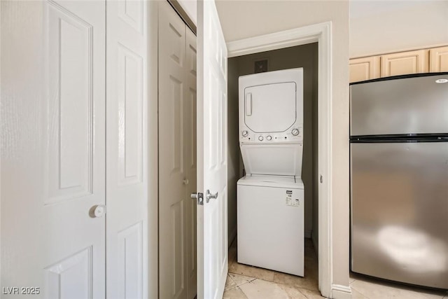 laundry area with stacked washer / drying machine