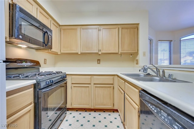 kitchen with light brown cabinetry, sink, and black appliances