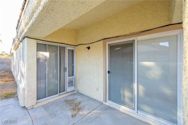 doorway to property with a patio area