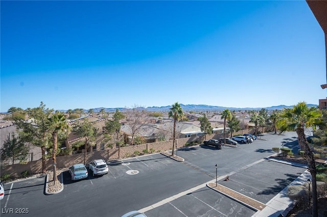 view of car parking featuring a mountain view