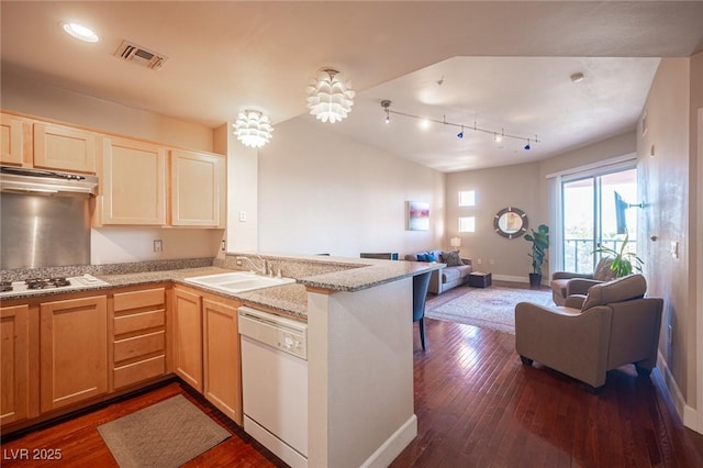 kitchen with white appliances, dark wood-type flooring, light brown cabinets, sink, and kitchen peninsula