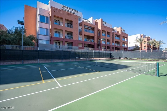 view of tennis court featuring basketball hoop